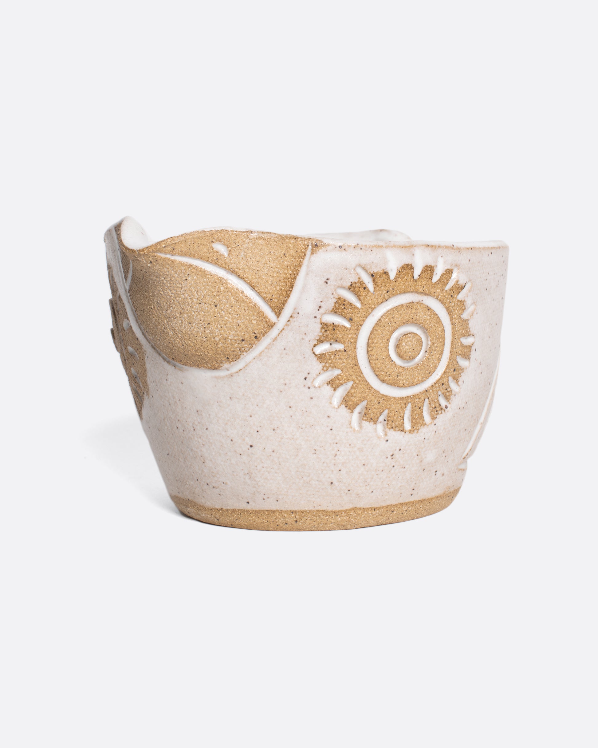 A handmade ceramic bird bowl whose beak serves as a spout, perfect for mixing and serving your favorite salad dressing.
