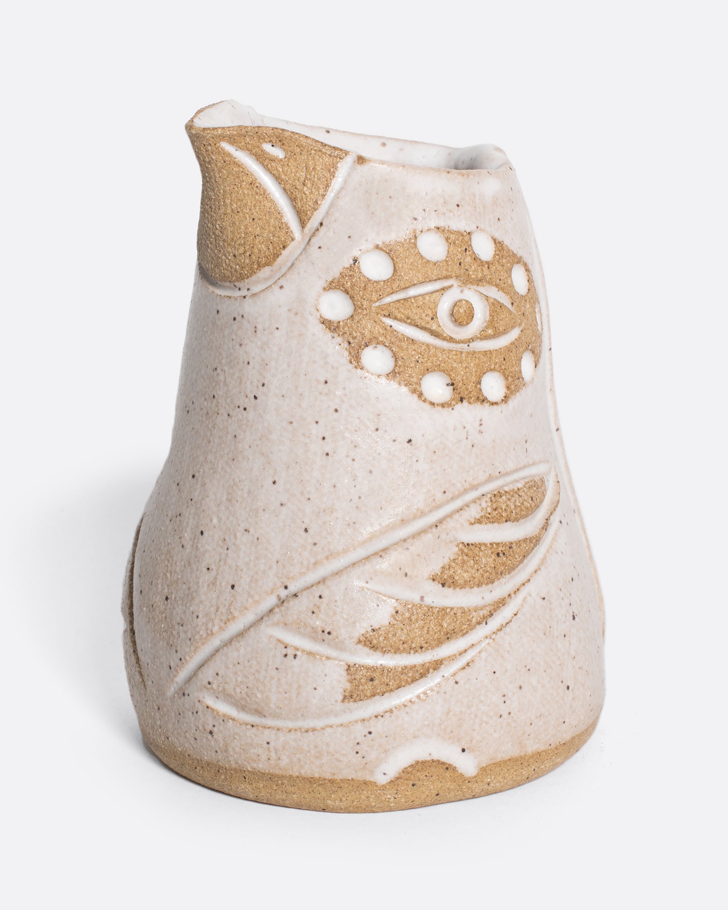 Close up of a creamer shaped like a bird in white and brown.