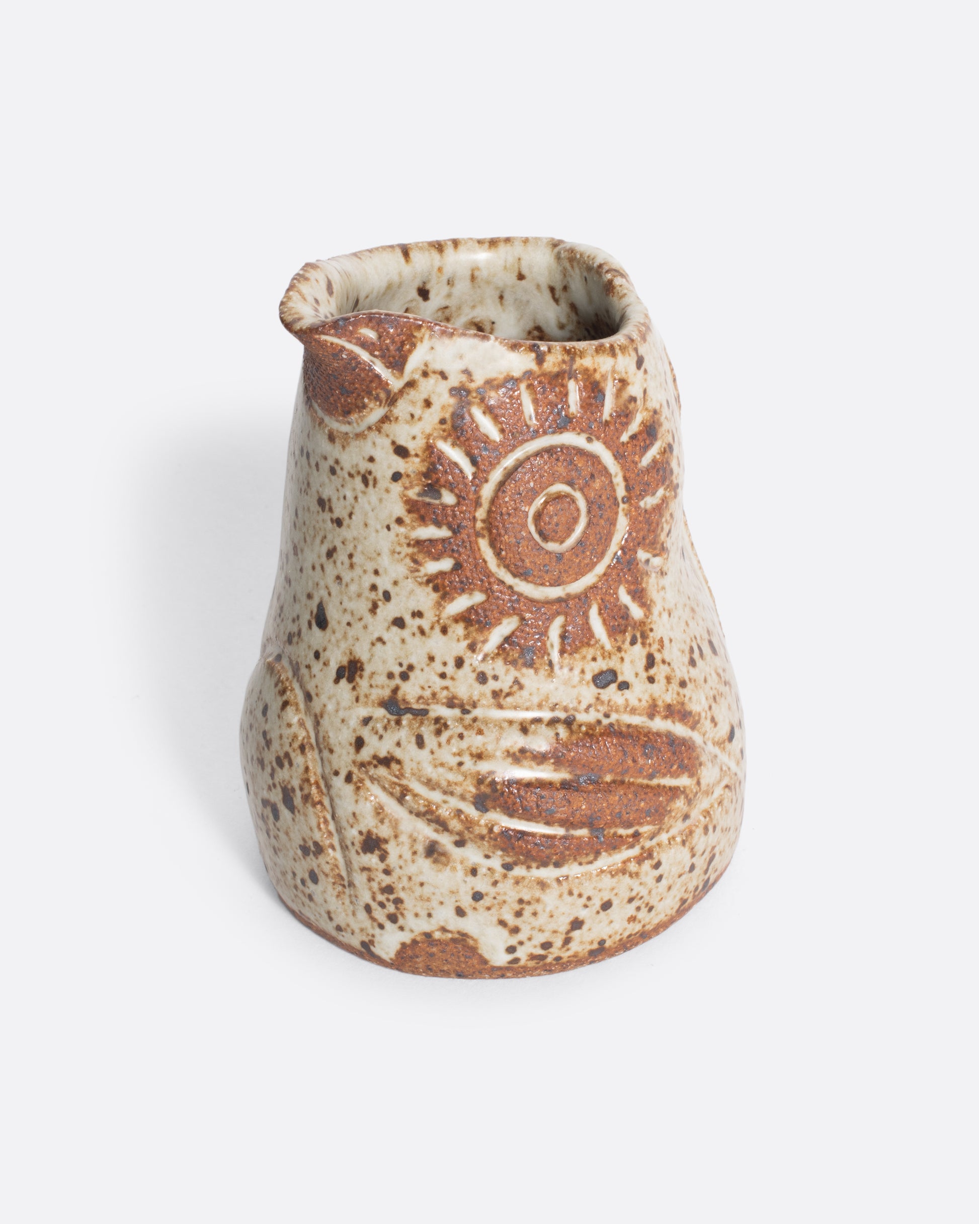 A handmade ceramic bird creamer, full of personality, with an impressionist design and speckled, satin glaze.