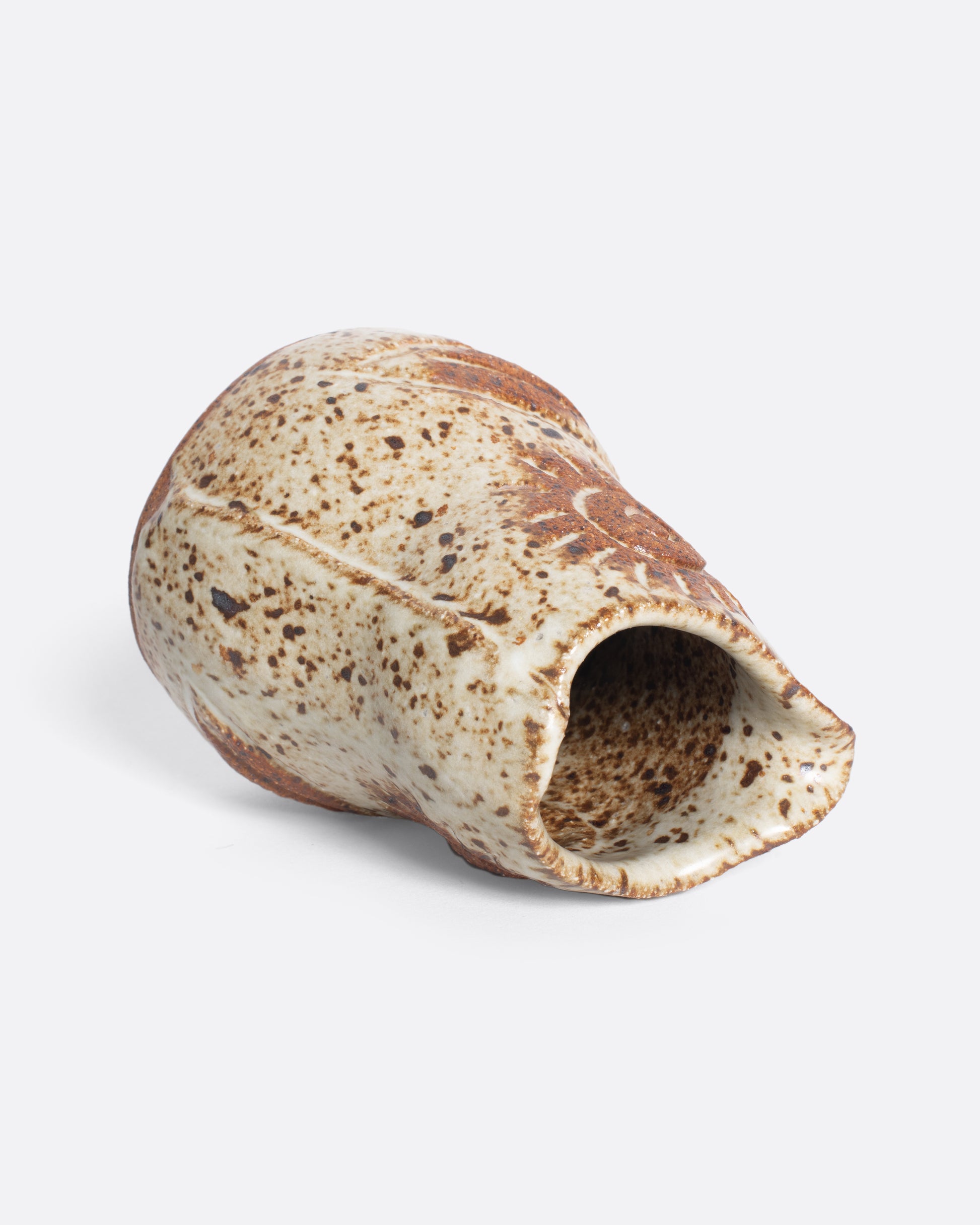A handmade ceramic bird creamer, full of personality, with an impressionist design and speckled, satin glaze.
