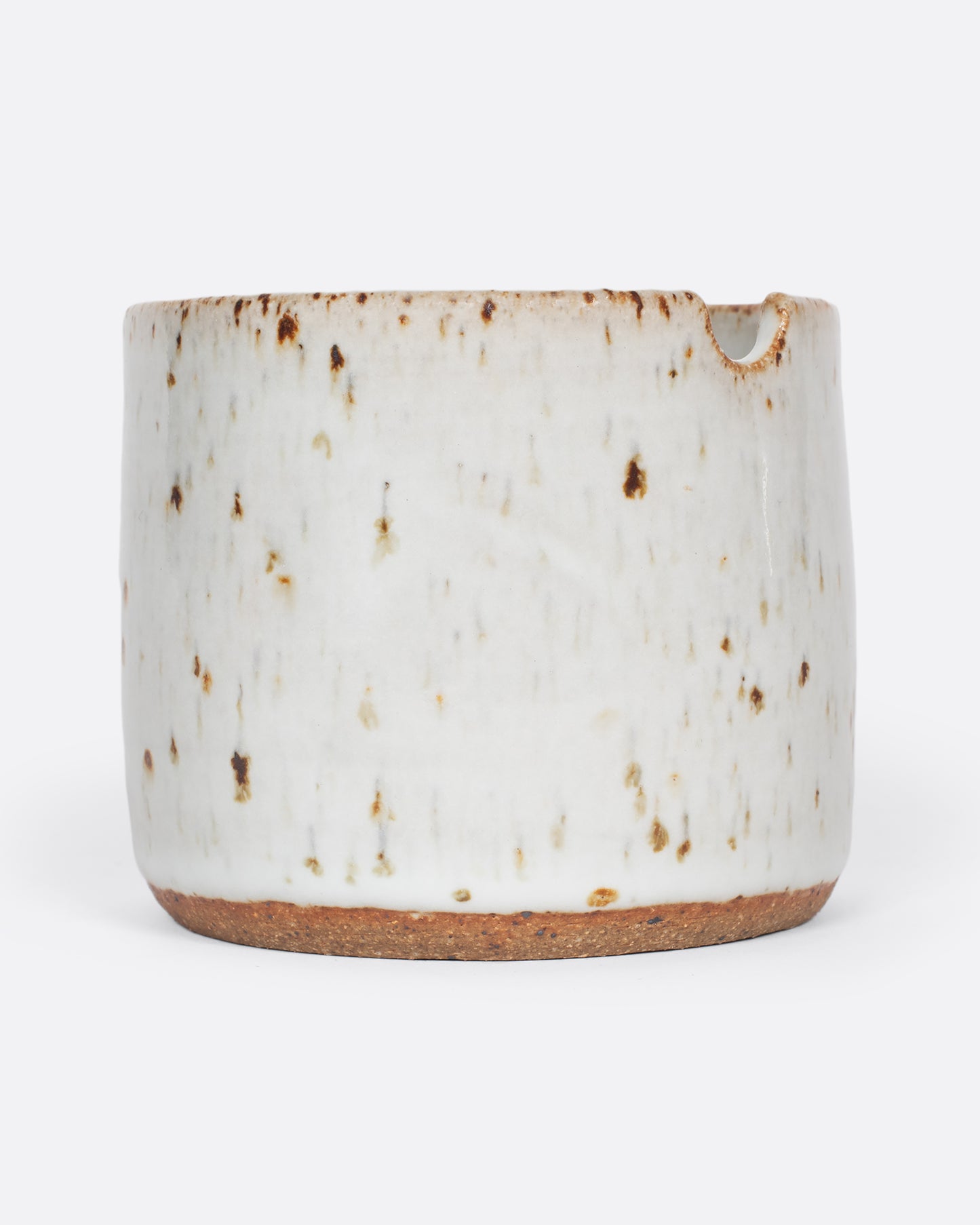 A side view photo of a ceramic paint cup.