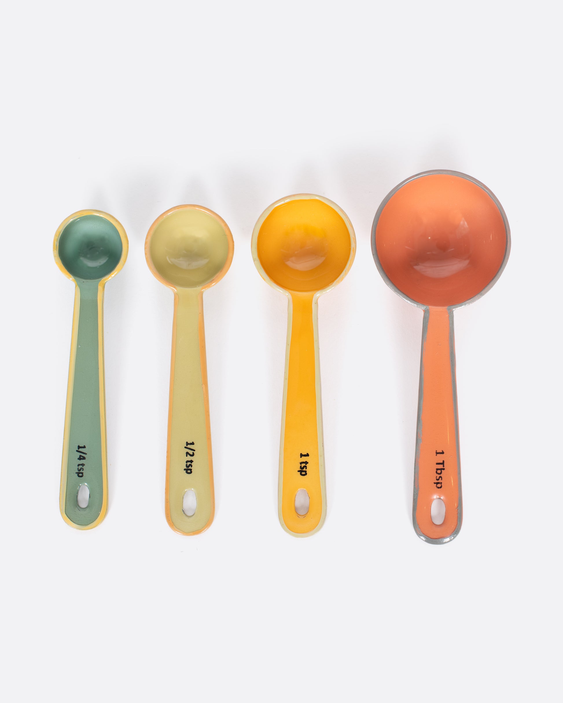 A set of four measuring spoons, each a different color.