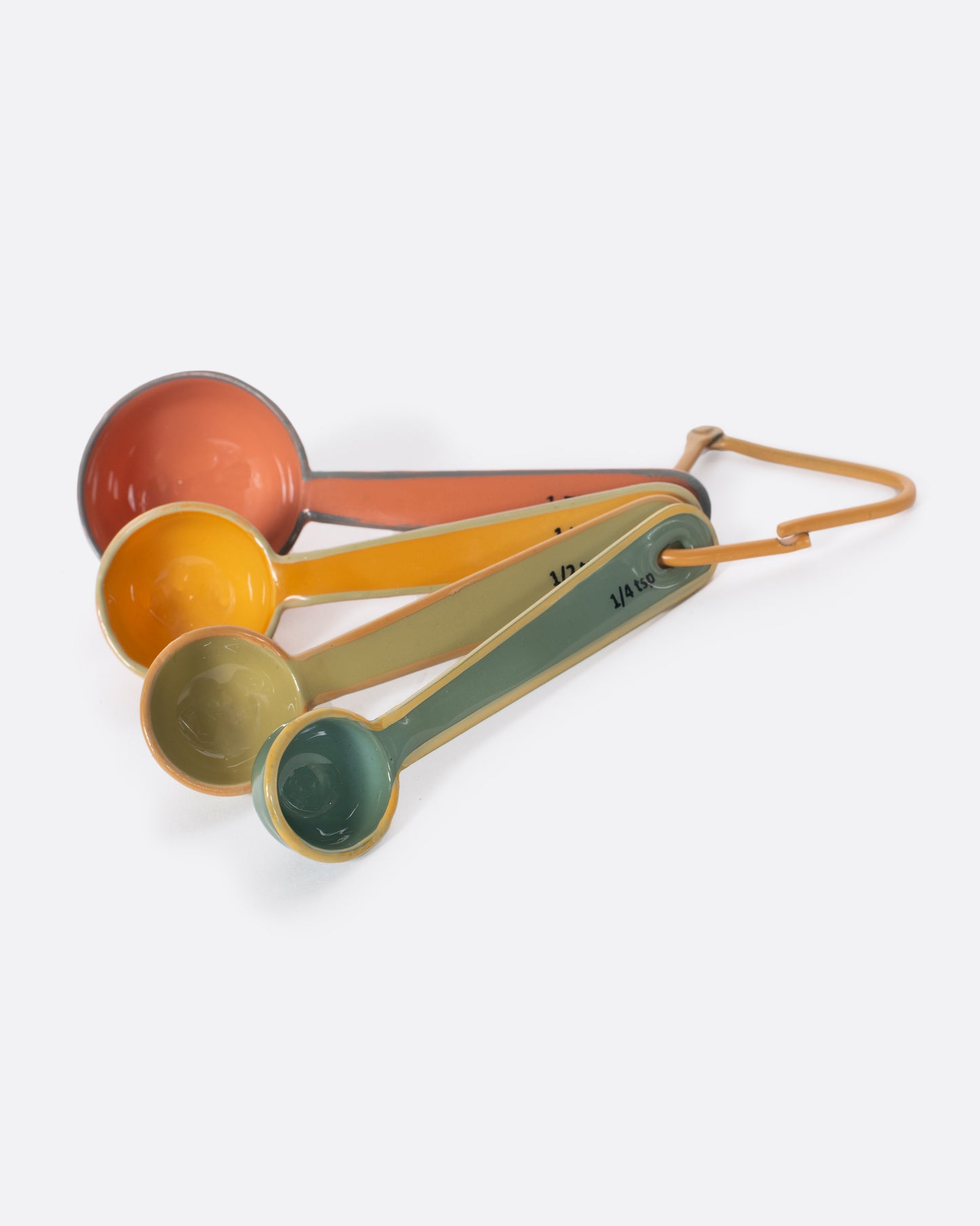 A set of four measuring spoons, each a different color, on a triangular carabiner. 