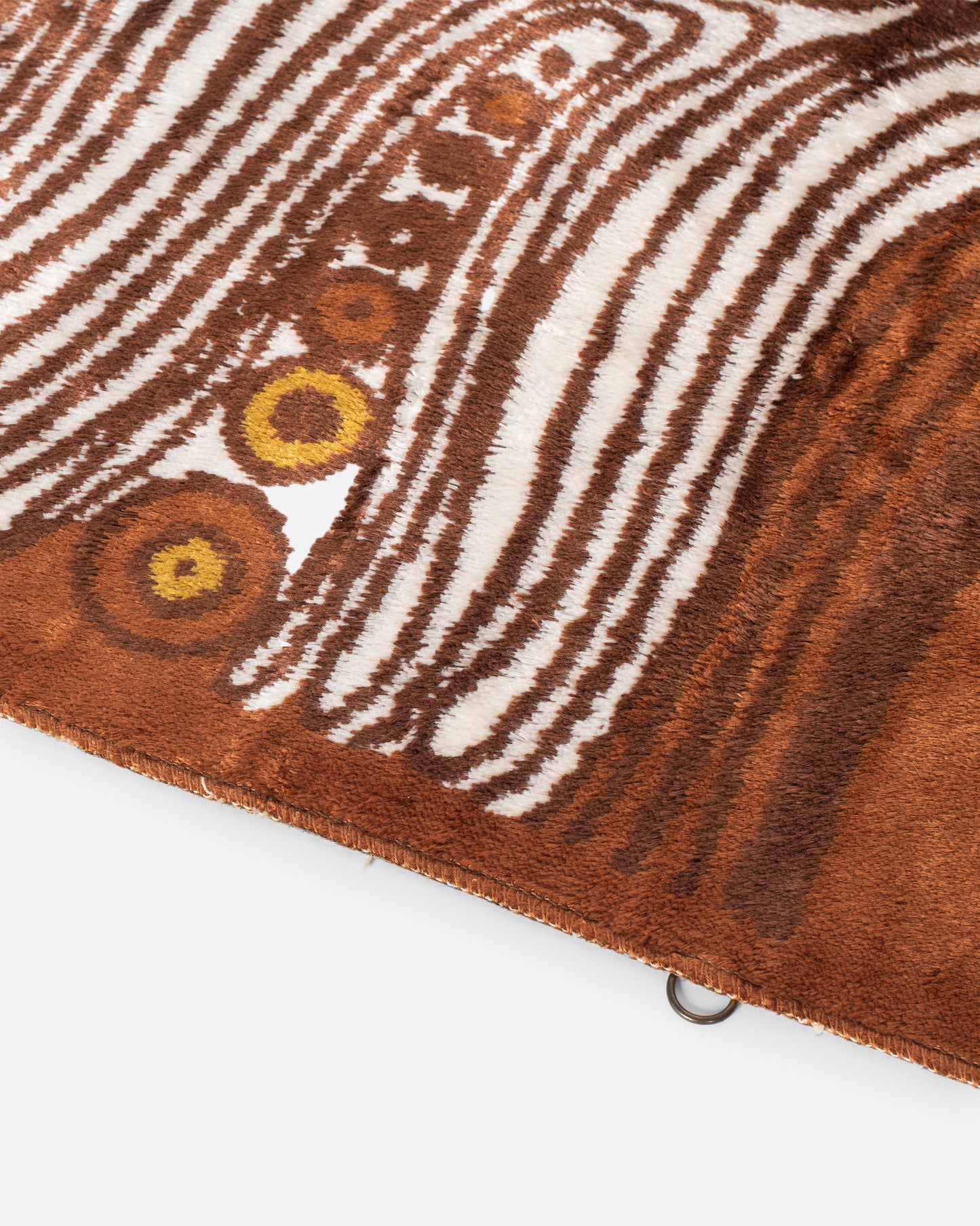 A unique Hungarian mid-century modern rug featuring organic white and brown lines intertwined with an array of orange and brown circles that look like treasures hidden among layers of rock