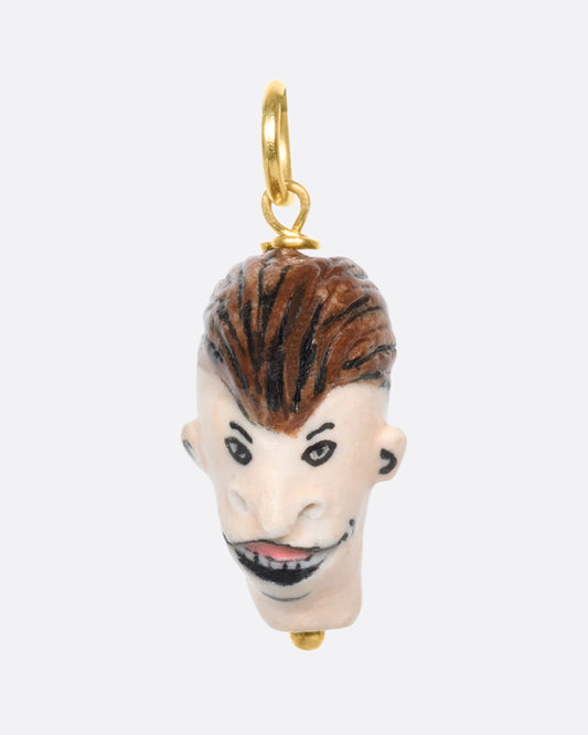 A handmade and painted porcelain Butt-Head charm with a 14K gold bail.