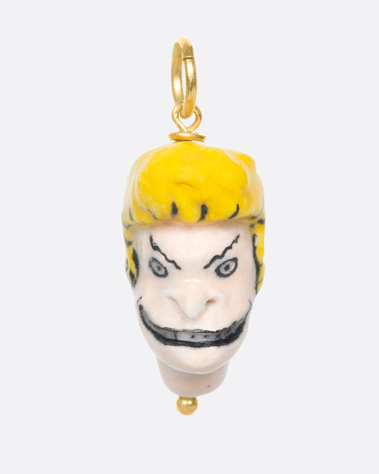 A handmade and painted porcelain Beavis charm with a 14k gold bail