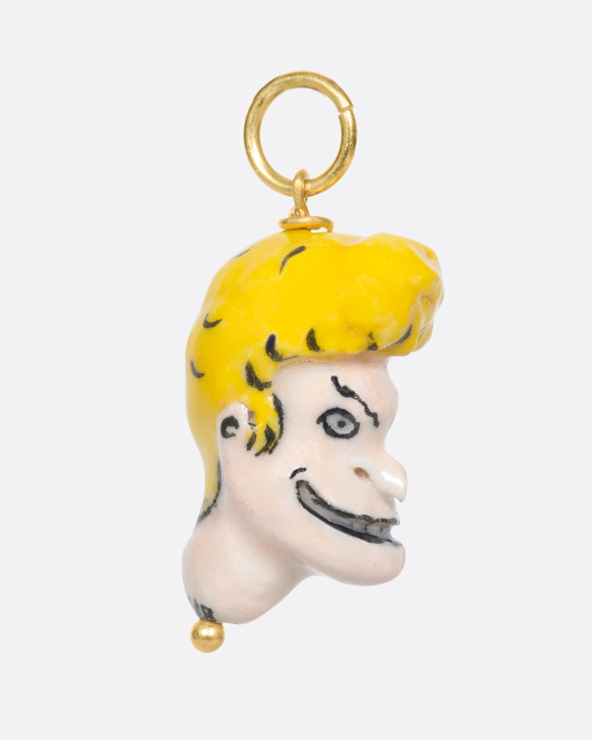 A handmade and painted porcelain Beavis charm with a 14k gold bail