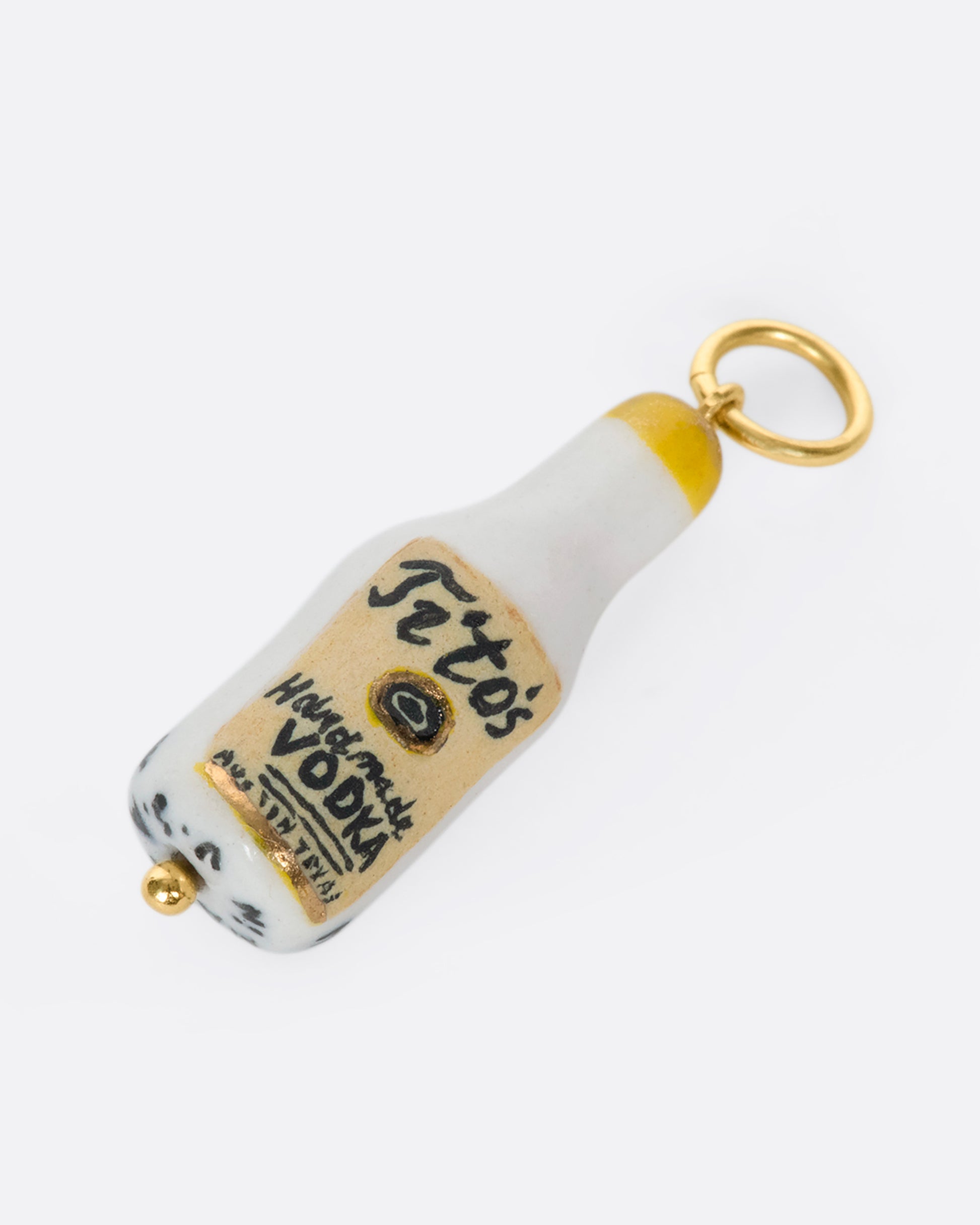 A handmade and painted porcelain Tito's Vodka charm with a 14k gold bail.