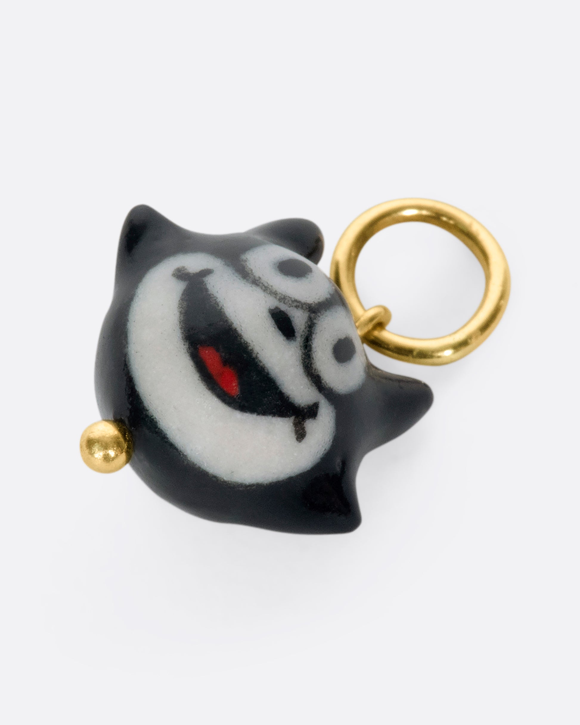 A handmade and painted porcelain Felix the Cat charm with a 14k gold bail