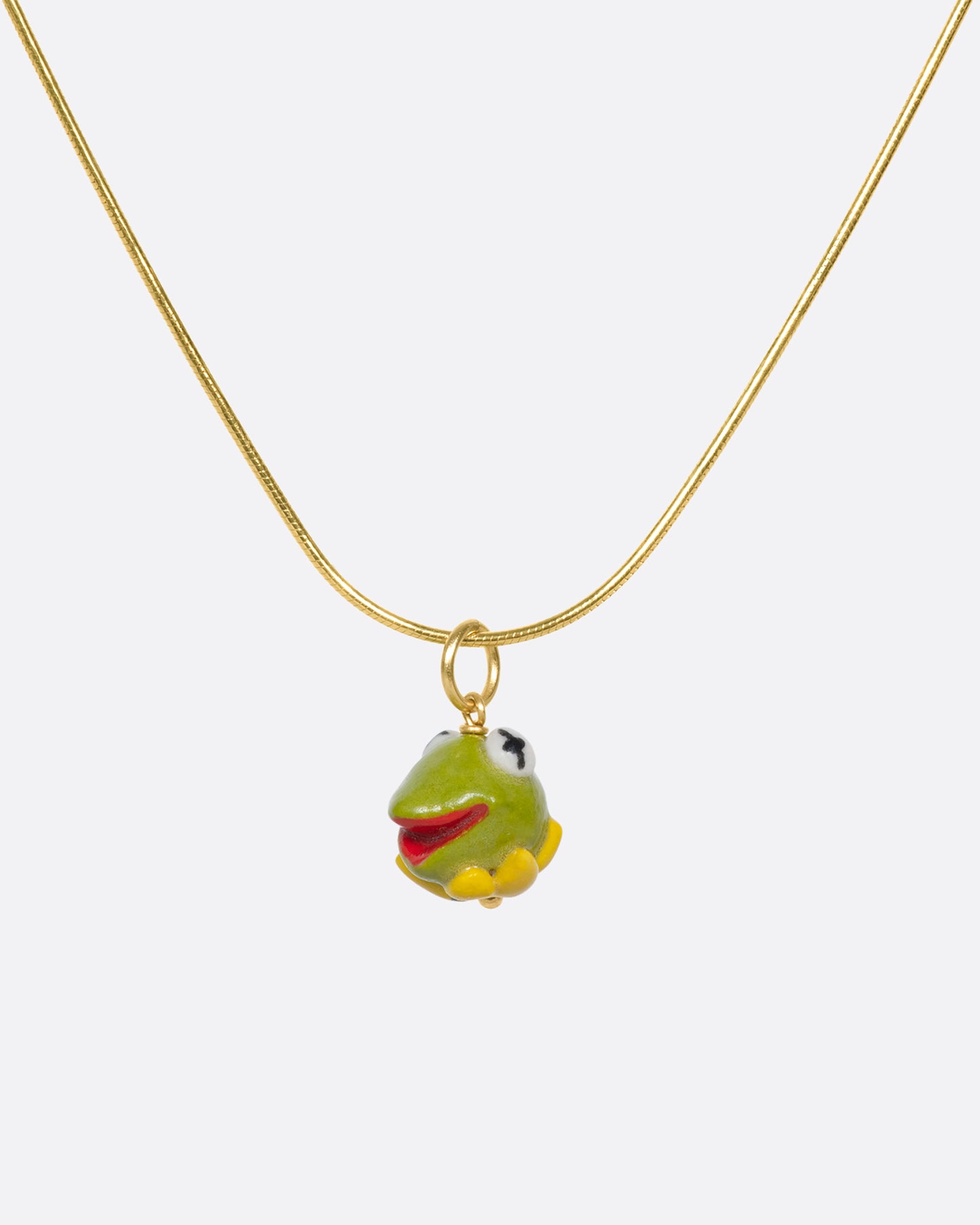 A handmade and painted porcelain Kermit the Frog charm with a gold bail.