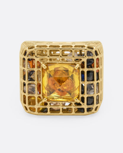 Yellow gold and yellow sapphire cage ring, top view of the square yellow sapphire framed by a gold grid holding multicolor sapphires and diamonds