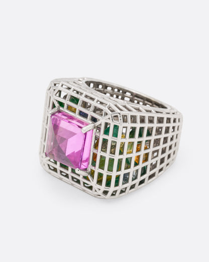 White gold and pink sapphire cage ring, side view with the pink sapphire facing left