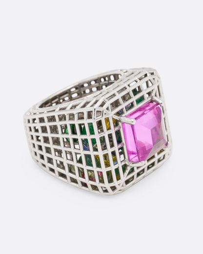 Sara Katherine Jacobson Cagey Dome ring in white gold, a square pink sapphire on an openwork cage filled with loose emeralds and multicolor sapphires