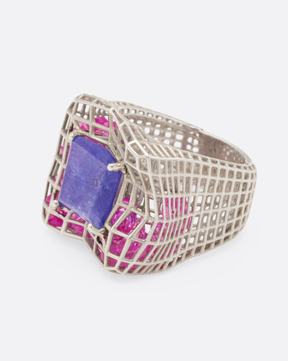 Sterling silver and blue quartz cage ring, side view with the blue quartz facing left and the tapered openwork shank