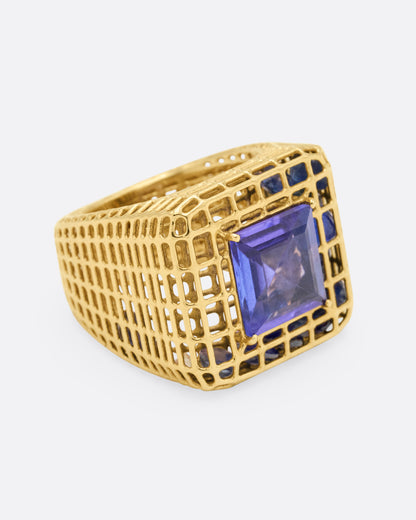 Yellow gold and tanzanite cage ring, side view with the tanzanite facing right