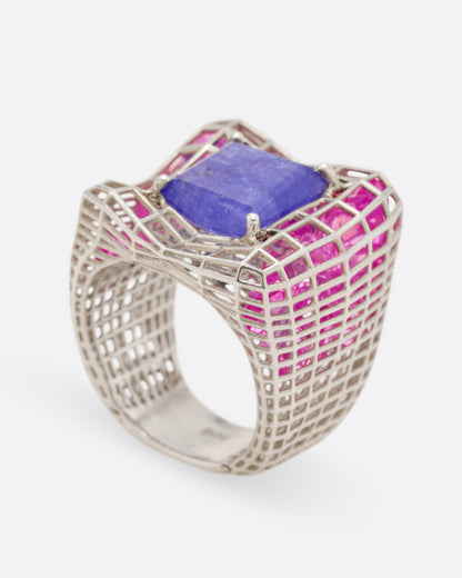 Sara Katherine Jacobson Cagey Distorted ring in sterling silver, a square blue quartz on a warped openwork cage filled with loose pink topaz