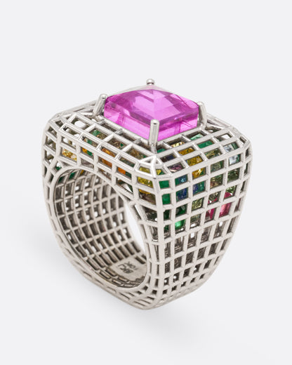 White gold and pink sapphire cage ring, angled view showing the pink sapphire set high on the white gold cage dome