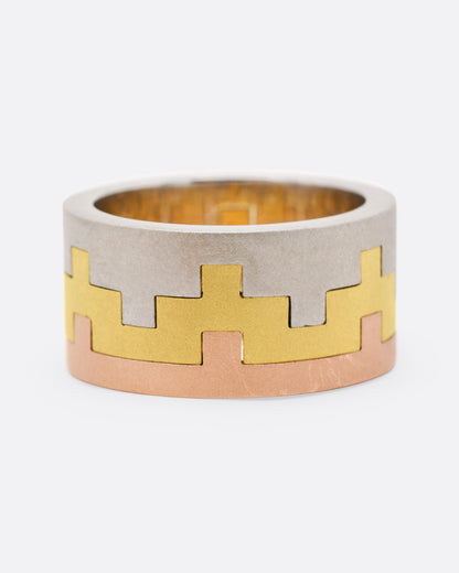 Sara Katherine Jacobson Tetris Trio ring, three stacked bands in white, yellow and rose gold with interlocking notched edges