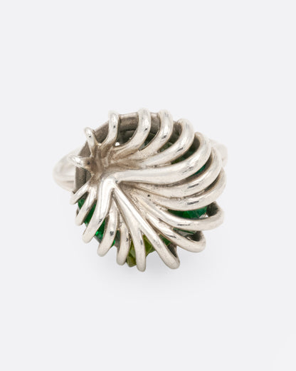 Sterling silver swirl cage ring with peridot, top view of the wires swirling in to the center