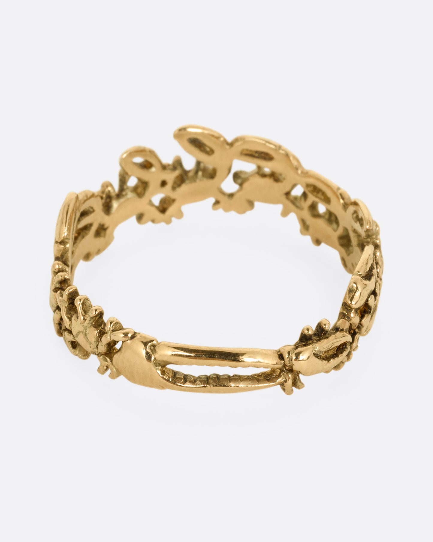 A yellow gold ring with a queue of crabs. Shown from the back.