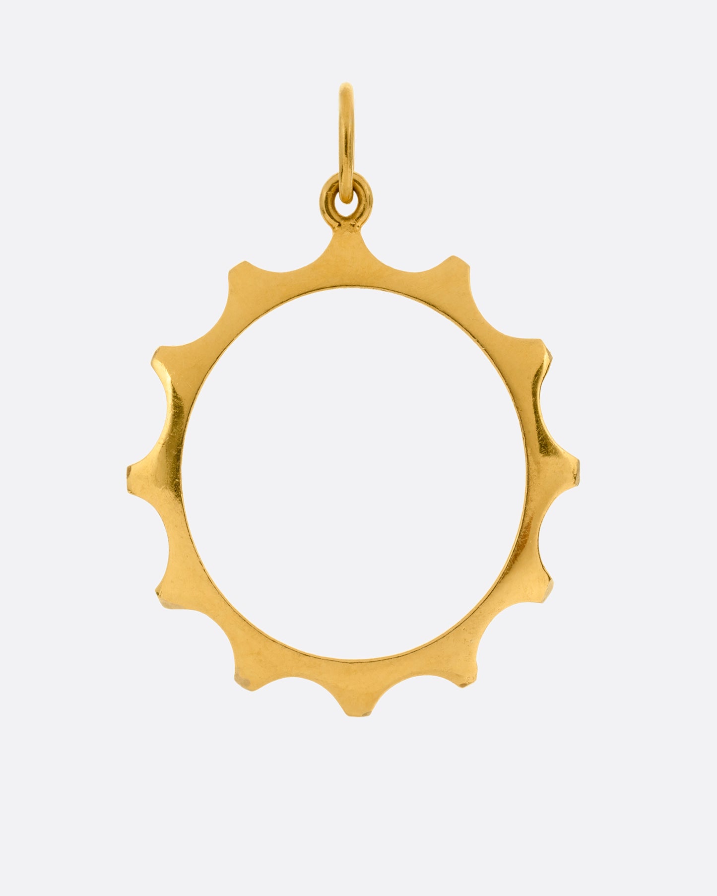 A yellow gold sun charm with an open center shown from the front.