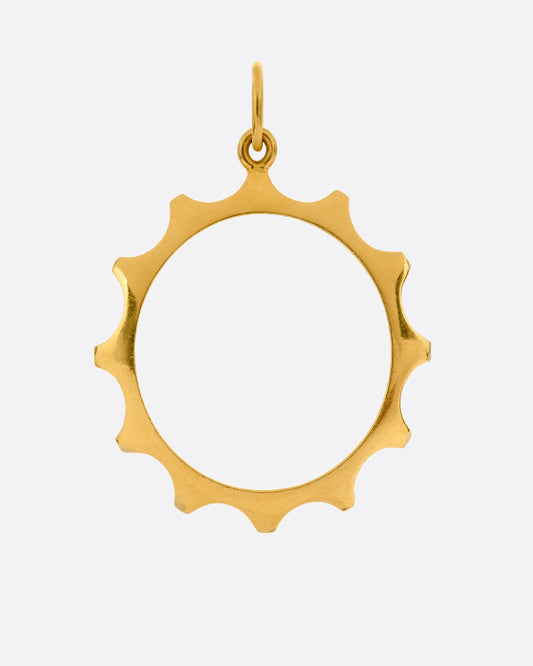 A yellow gold sun charm with an open center shown from the front.