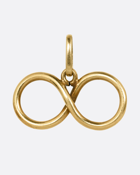 A yellow gold infinity pendant shown from the front.