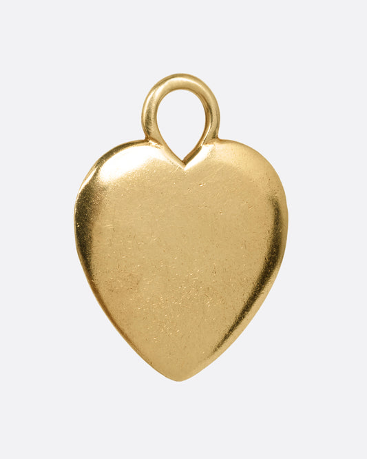 A yellow gold heart charm shown from the front.