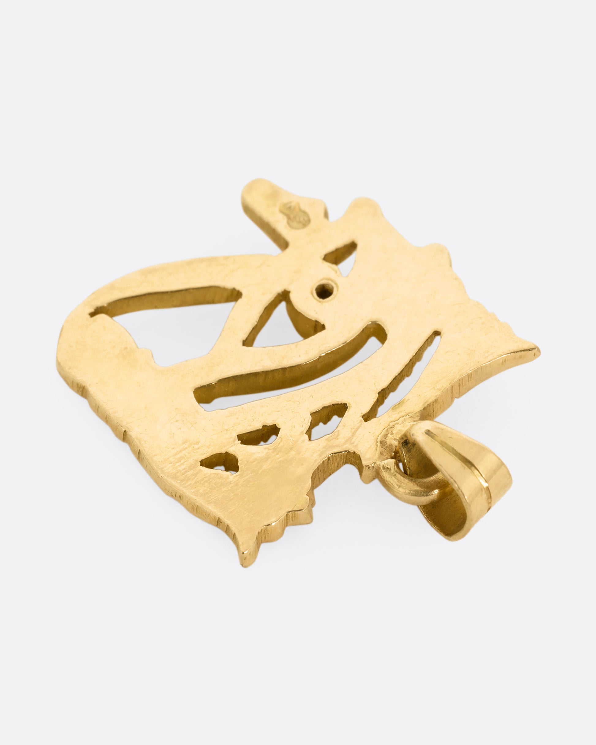 A yellow gold Eye of Horus pendant shown from the back.