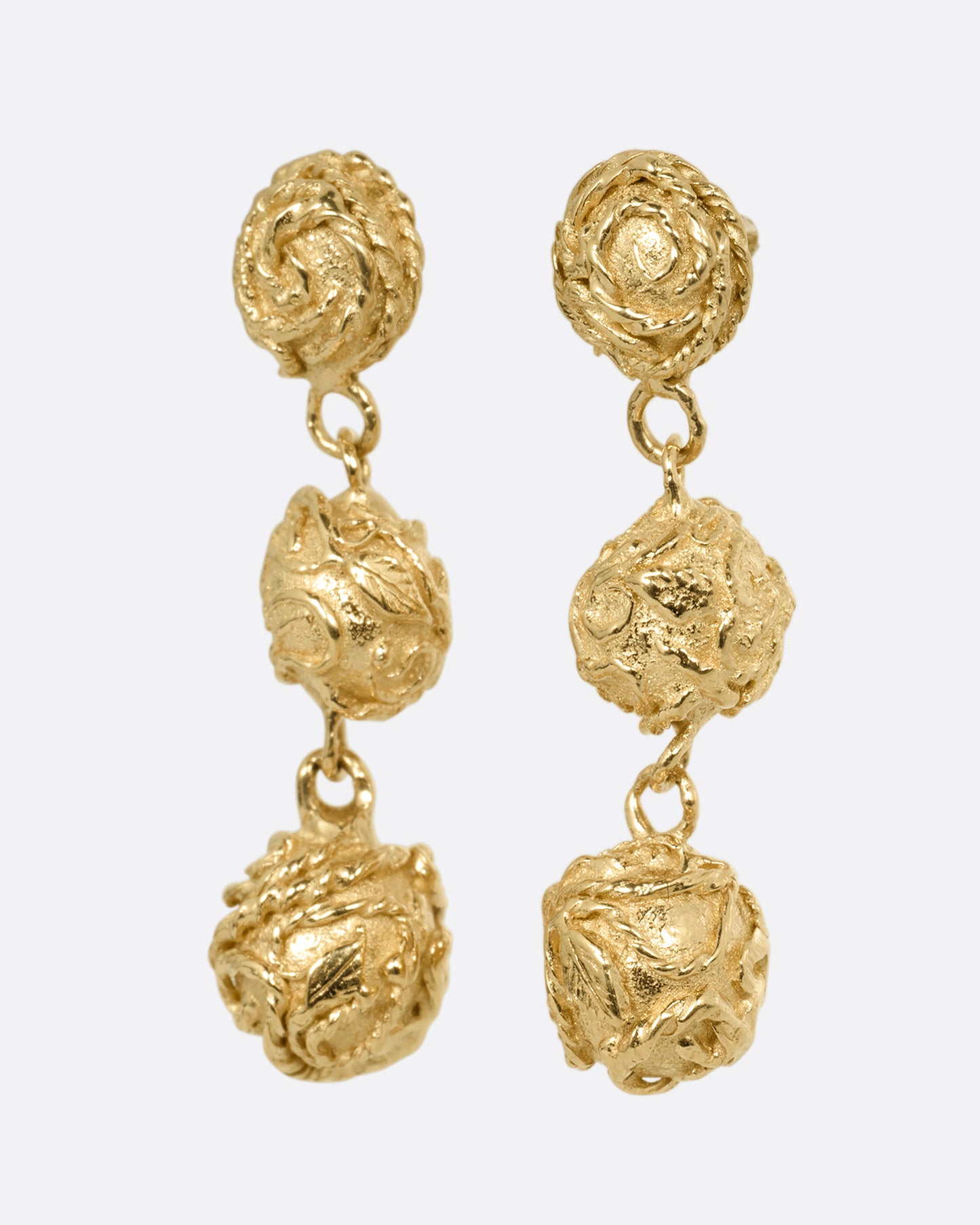A pair of yellow gold dangle earrings with three linked spheres. Shown from the front.