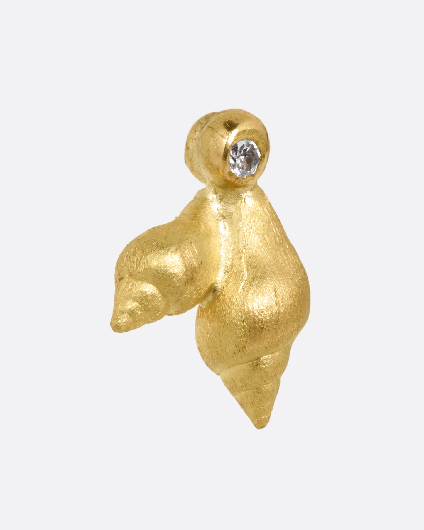 A yellow gold stud earring with two seashells and a diamond. Shown from the side.