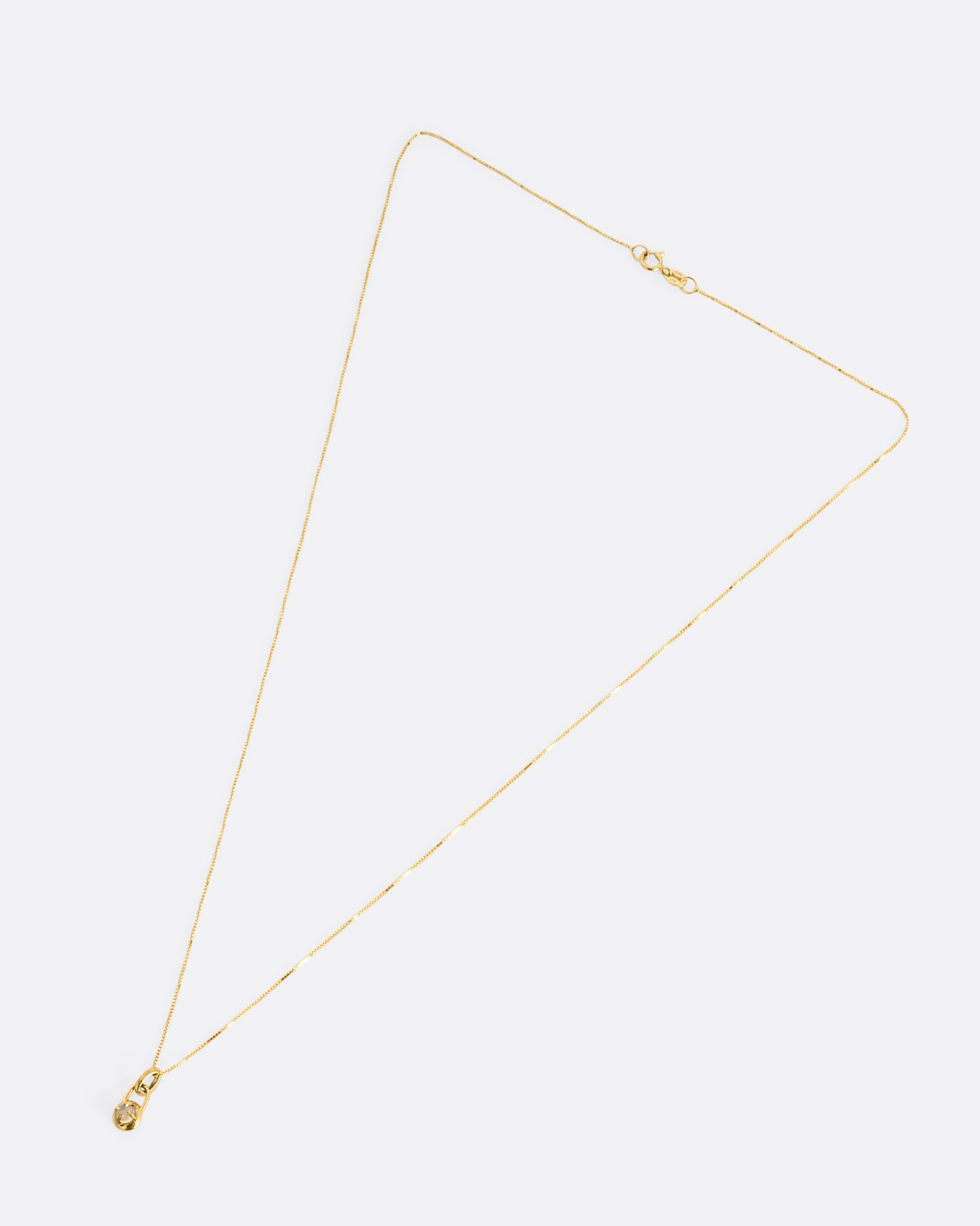 A yellow gold box chain necklace with a prong set opal cabochon pendant, shown from the front.