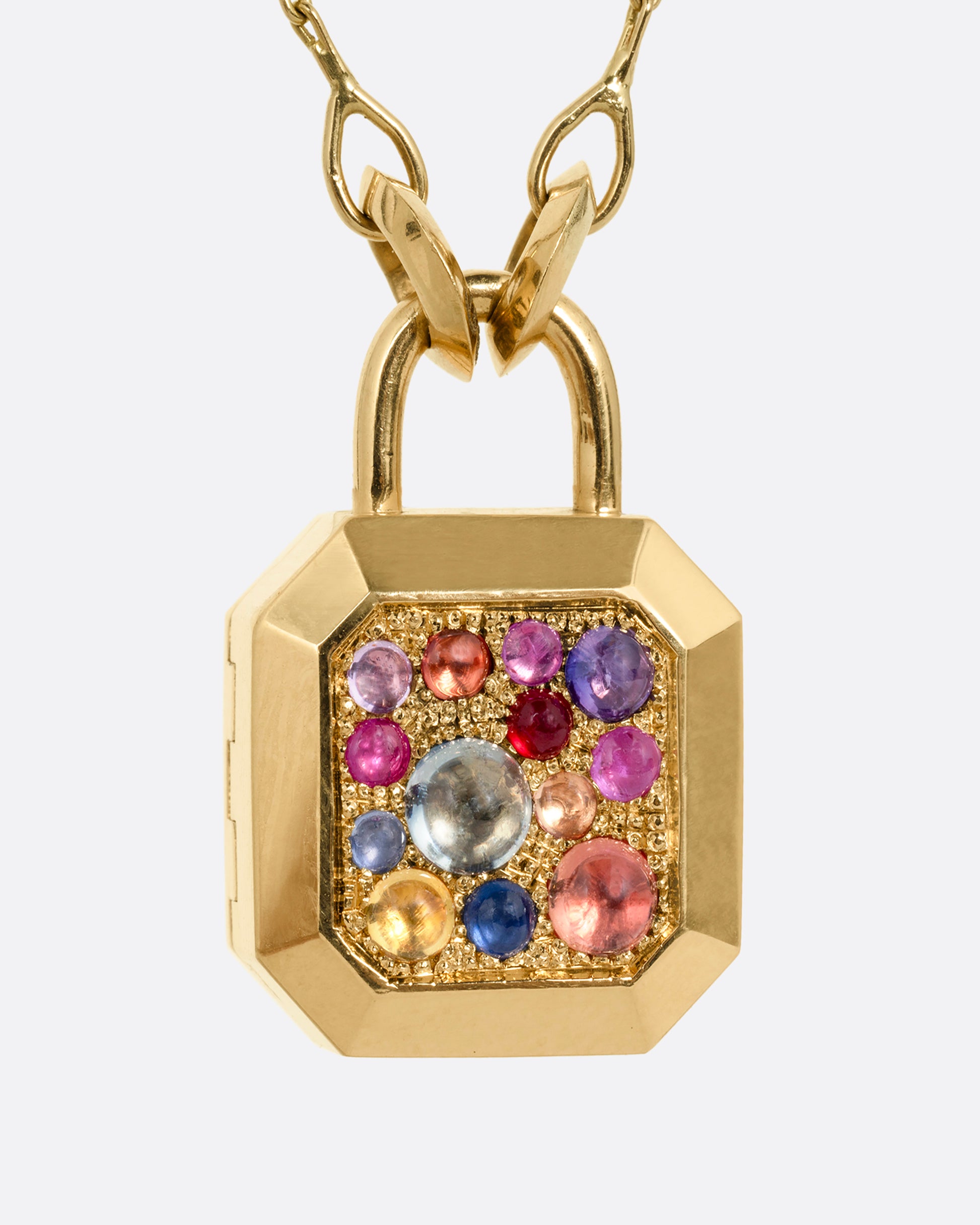 A yellow gold necklace with a padlock shaped locket pendant with multicolored sapphire on its face. Shown from the front.