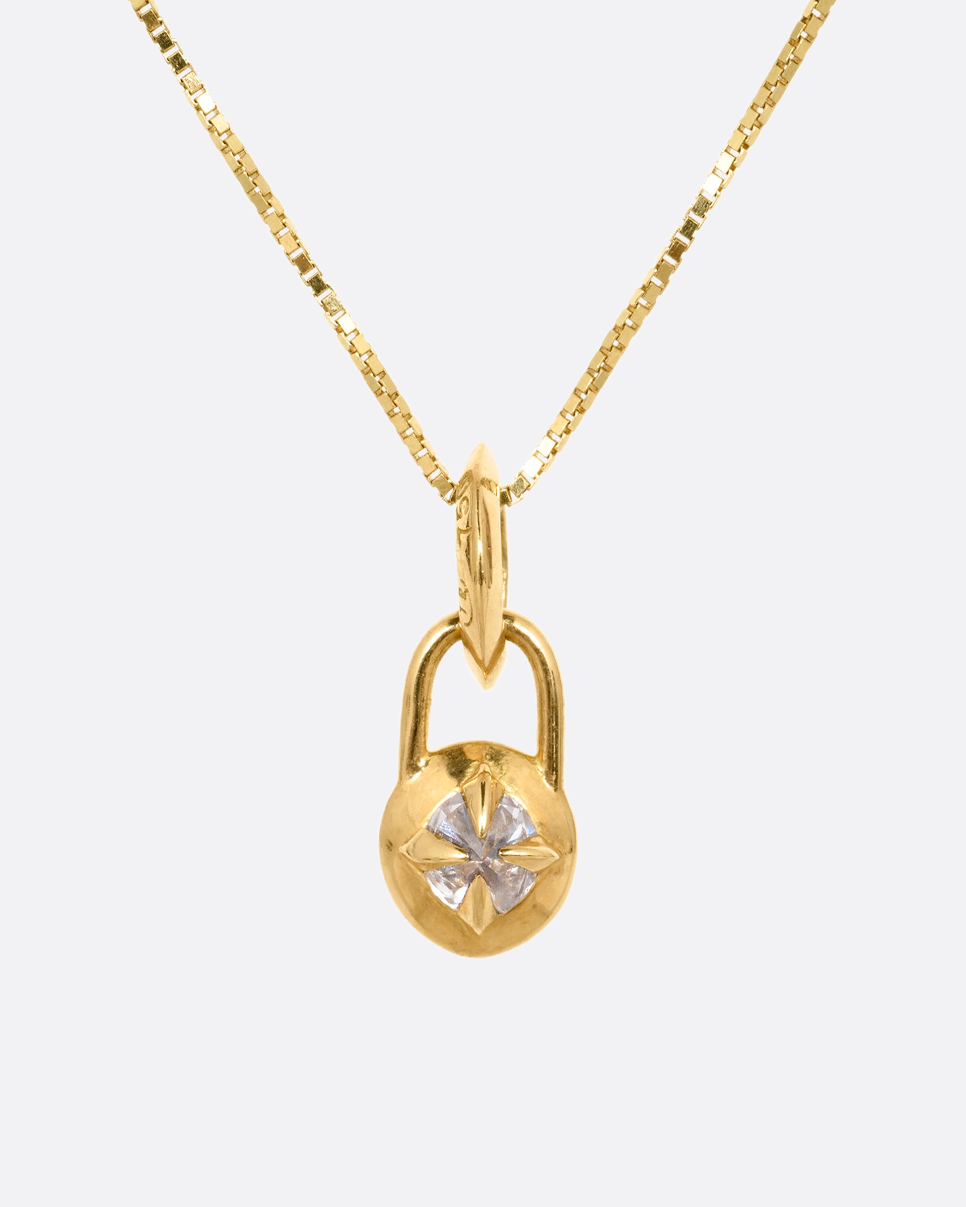 A yellow gold box chain with a padlock shaped pendant. A reverse set diamond is prong set in the center of the pendant. Shown from the front.