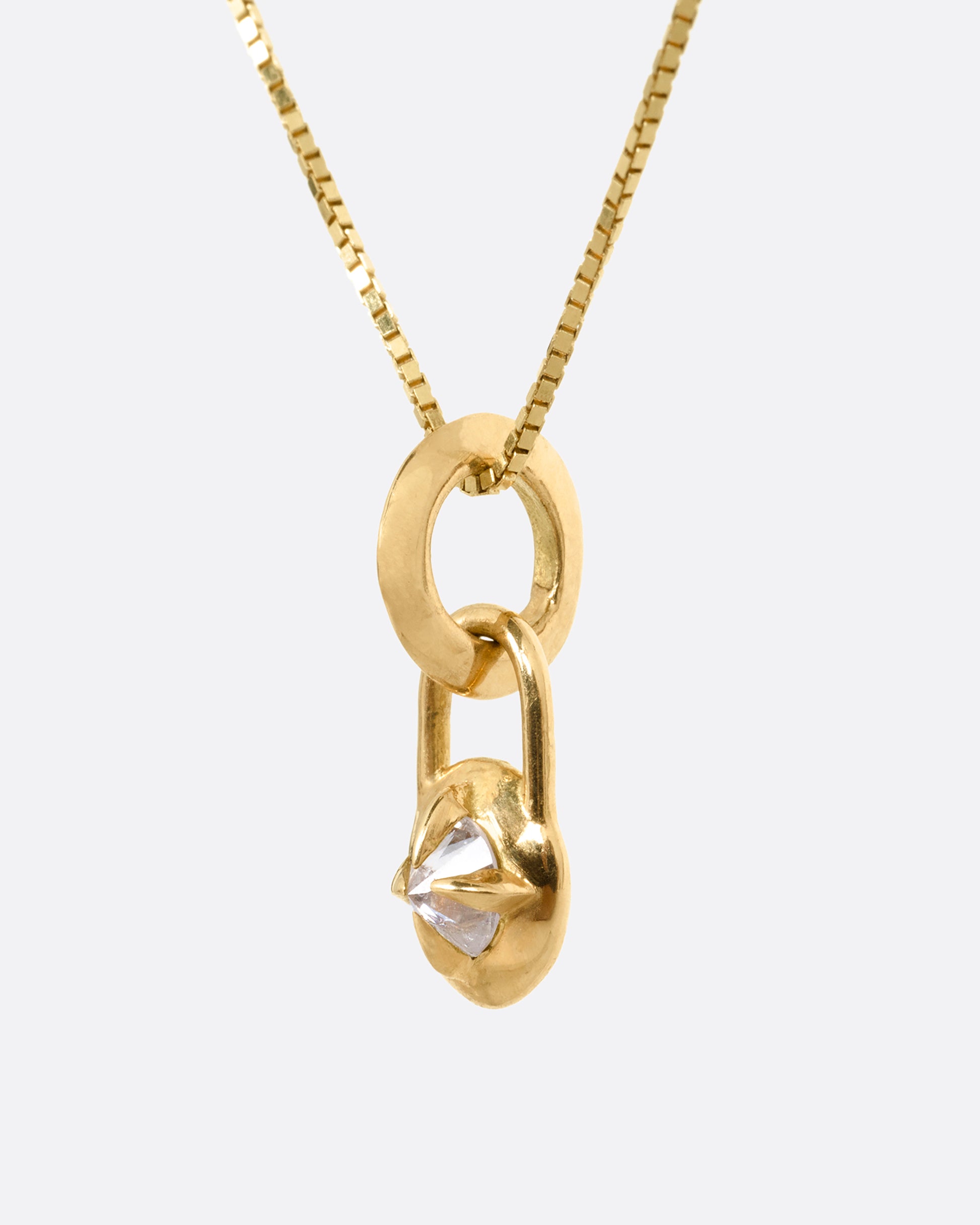 A yellow gold box chain with a padlock shaped pendant. A reverse set diamond is prong set in the center of the pendant. Shown from the side.