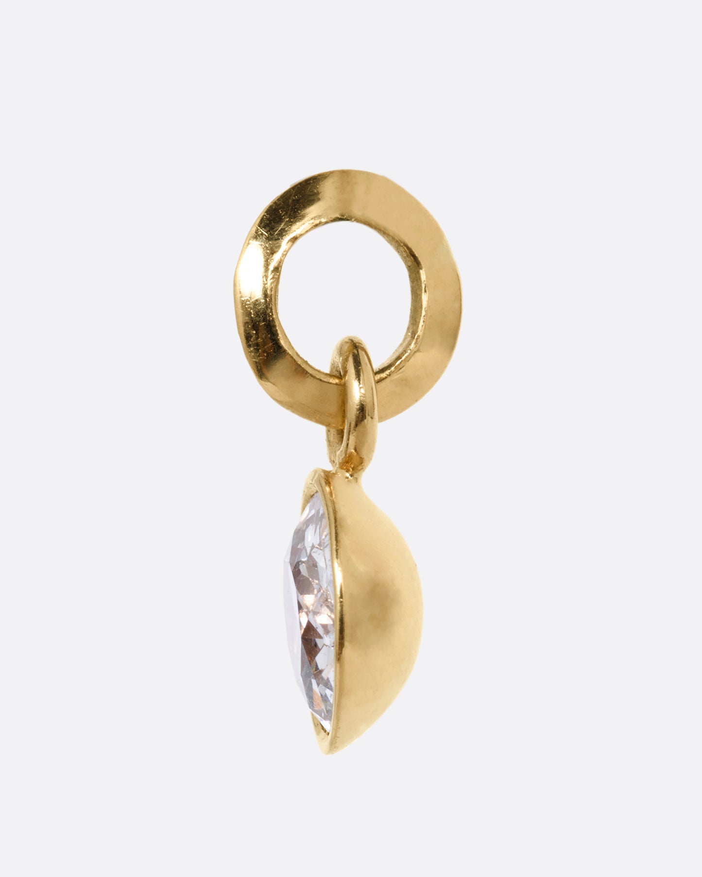 A round yellow gold pendant with an Old European cut diamond. Shown from the side.