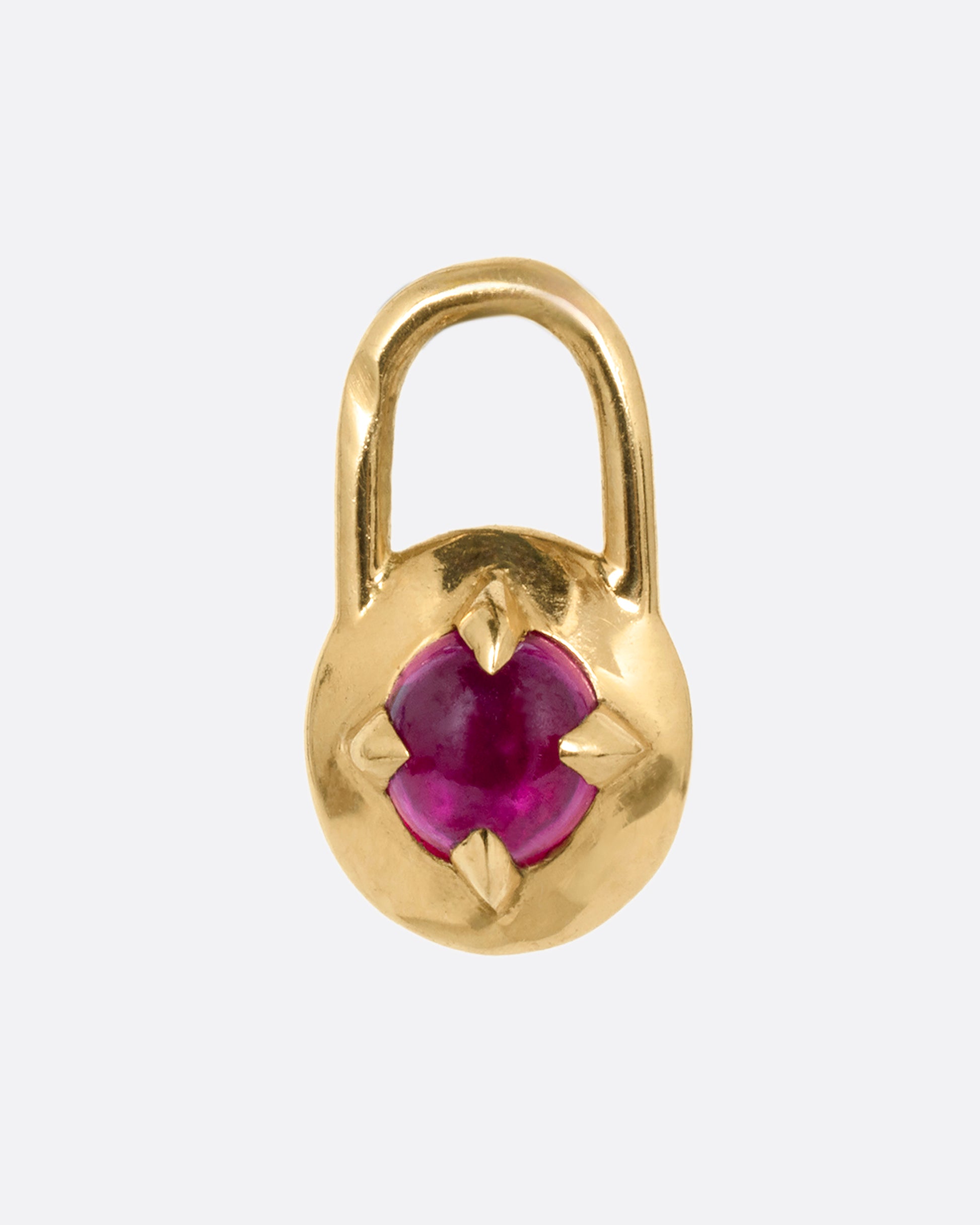 A yellow gold padlock shaped pendant with a prong set ruby cabochon. Shown from the front.