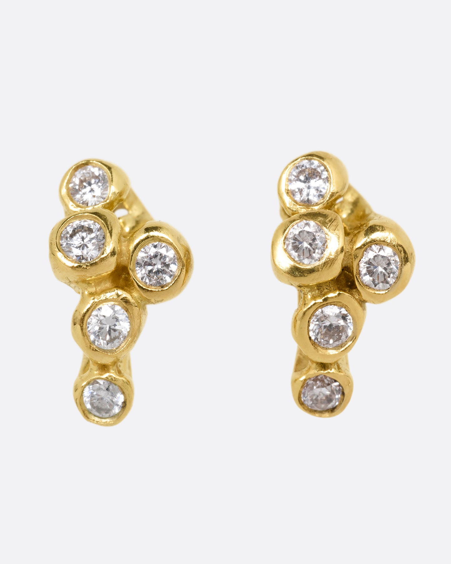 A pair of yellow gold earrings with sea anemone shaped clusters of diamonds. Shown from the front.