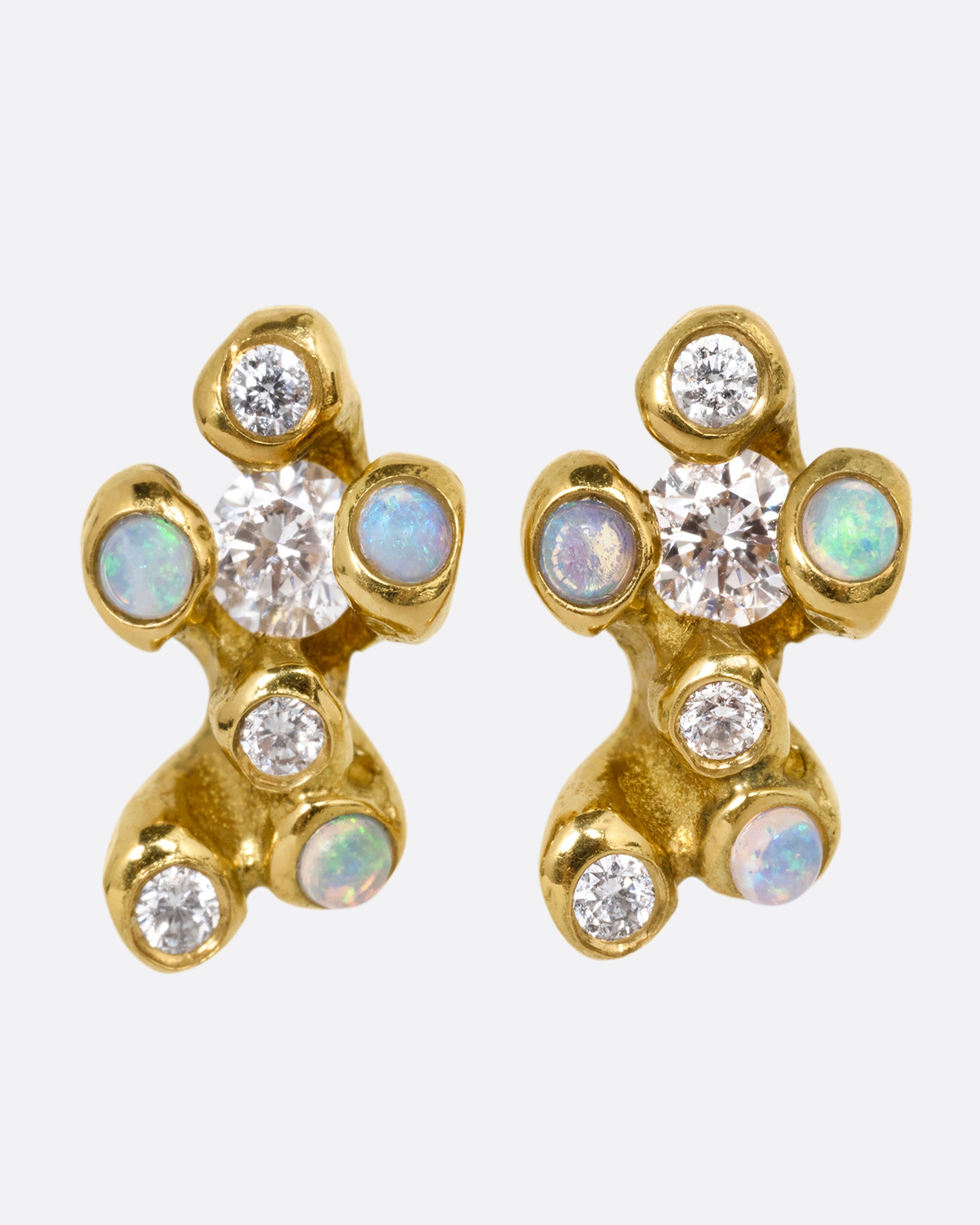 A pair of yellow gold stud earrings with clusters of diamonds and opals. Shown from the front.