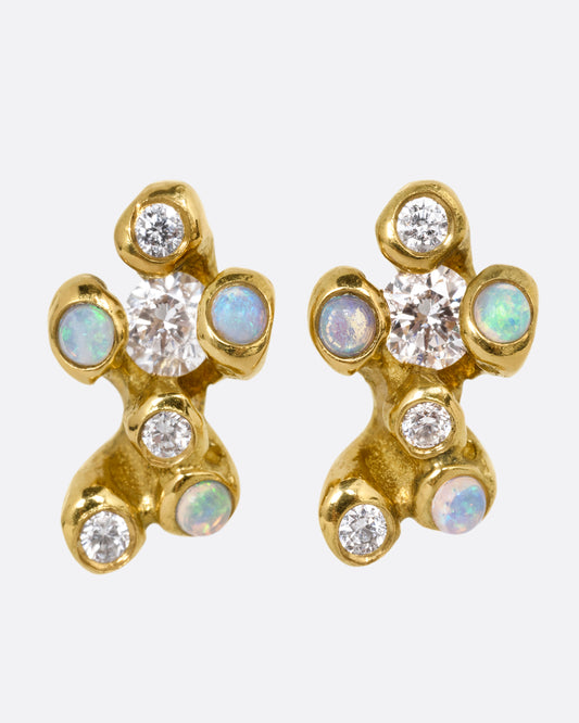 A pair of yellow gold stud earrings with clusters of diamonds and opals. Shown from the front.