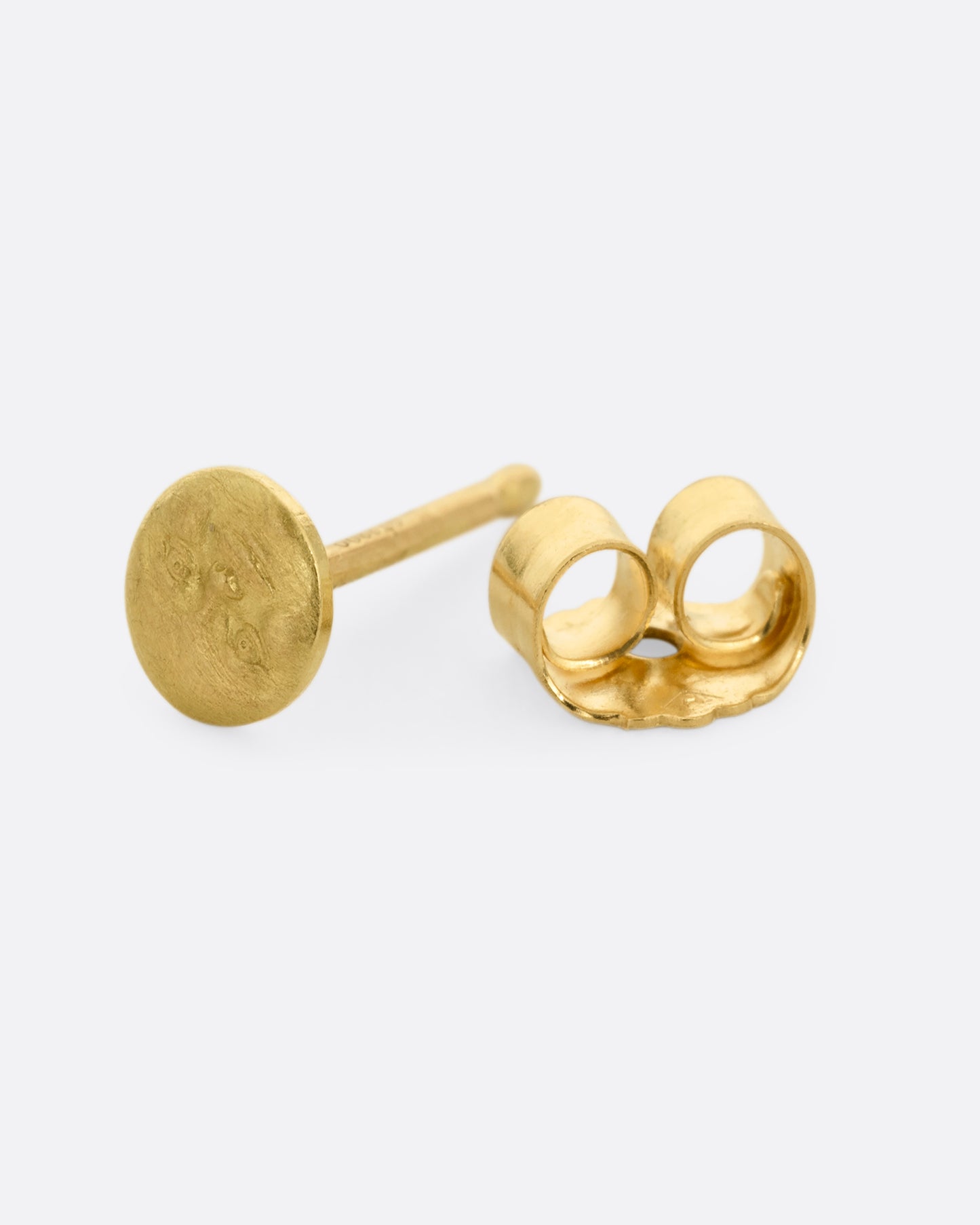 A yellow gold moon face stud earring. Shown from the side open.