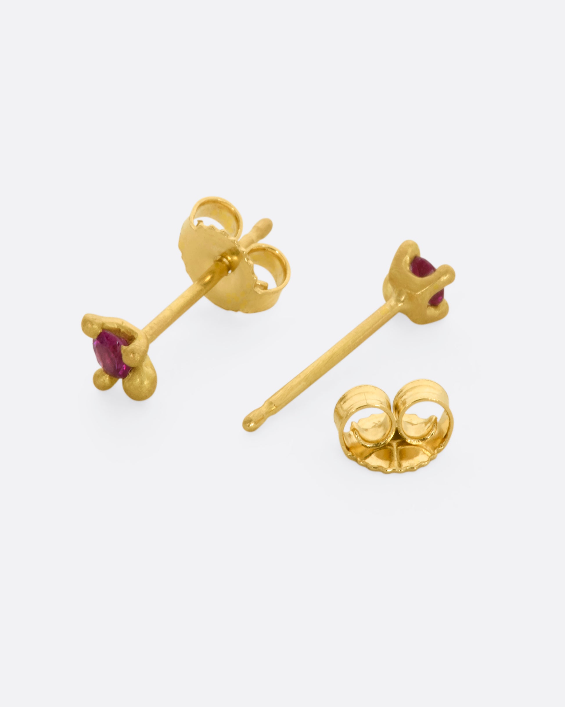 Yellow gold stud earrings with rubies. Shown from the front and back.