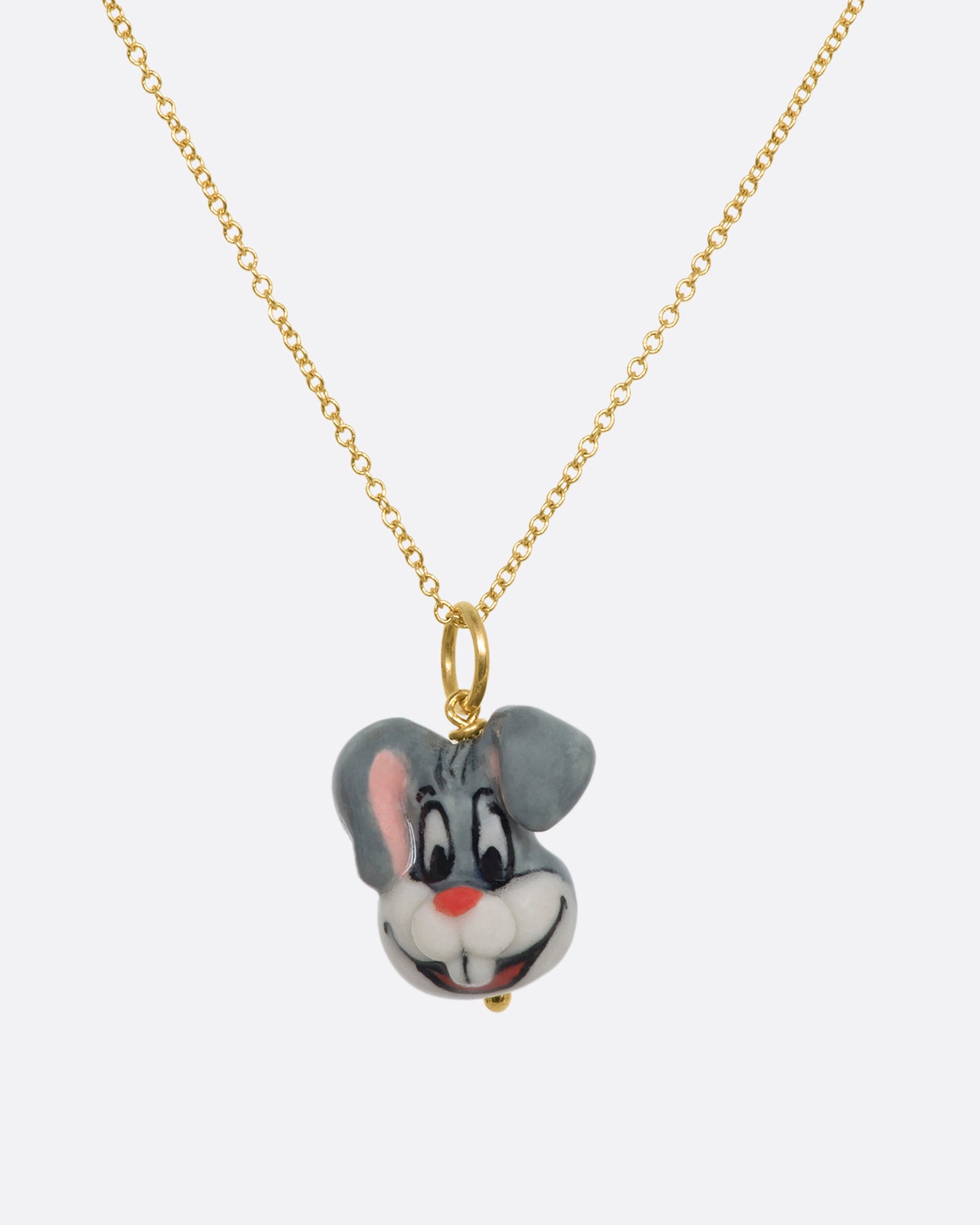 A grey three dimensional bugs bunny charm with a yellow gold bail. Hanging from a yellow gold chain.