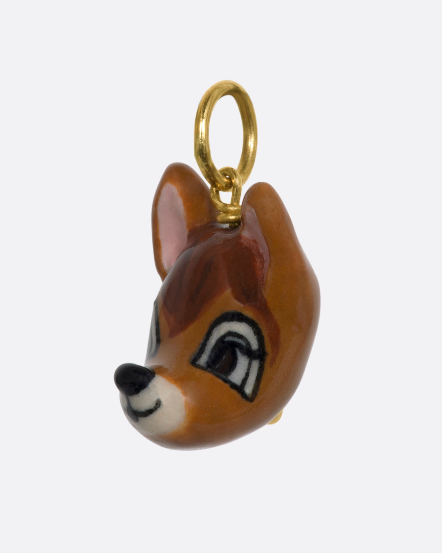 A hand painted 3D porcelain Bambi charm with a yellow gold bail. View from the side.