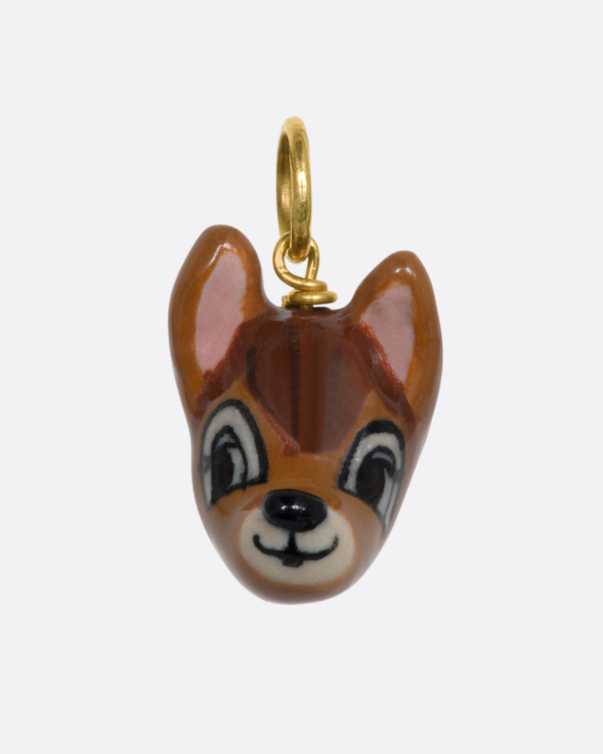 A hand painted 3D porcelain Bambi charm with a yellow gold bail. View from the front.