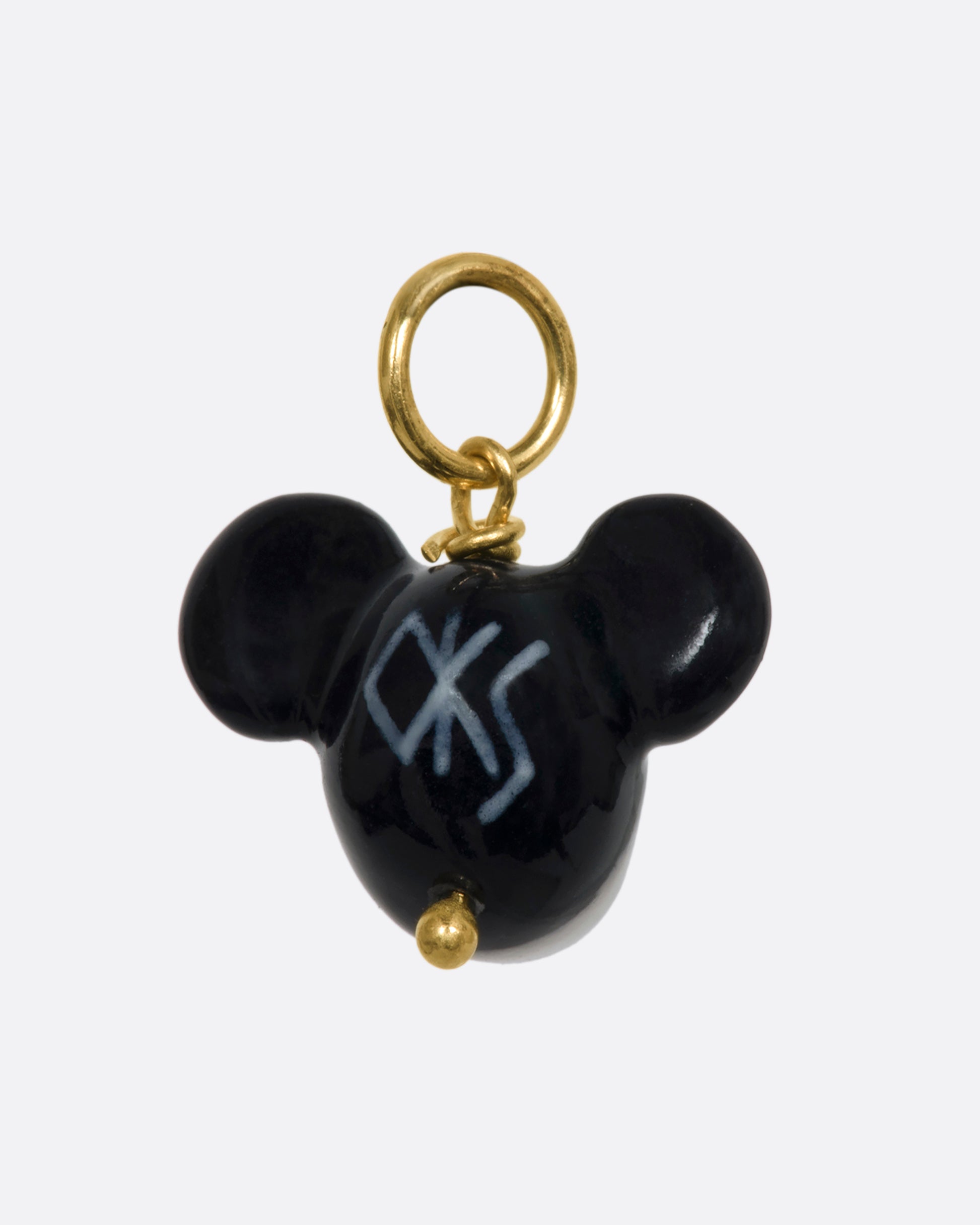 A three dimensional black and white era mickey mouse charm with a yellow gold bail. View from the back.