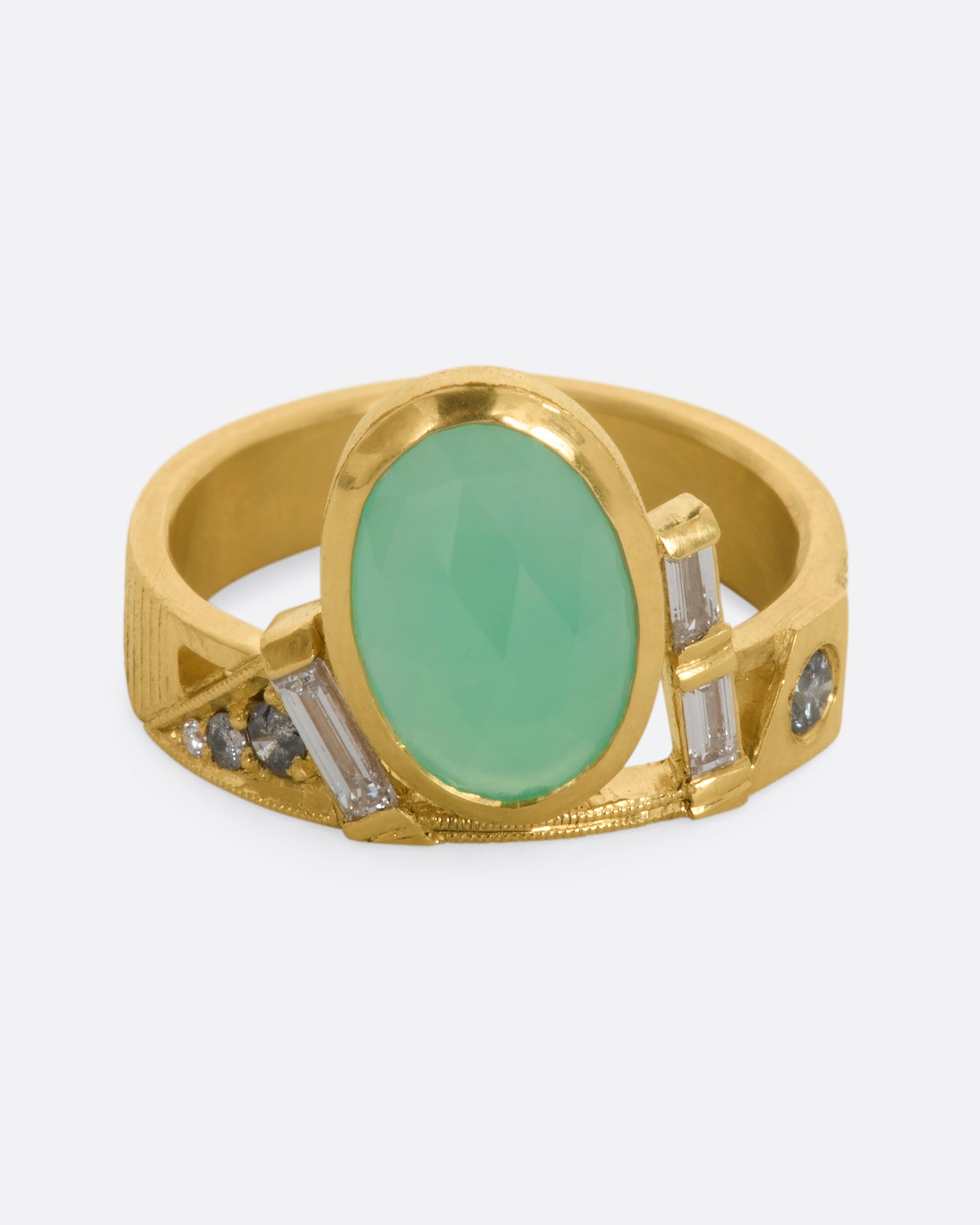 A yellow gold wide band ring with an oval chrysoprase, stacked baguette and round diamonds. View from the front.