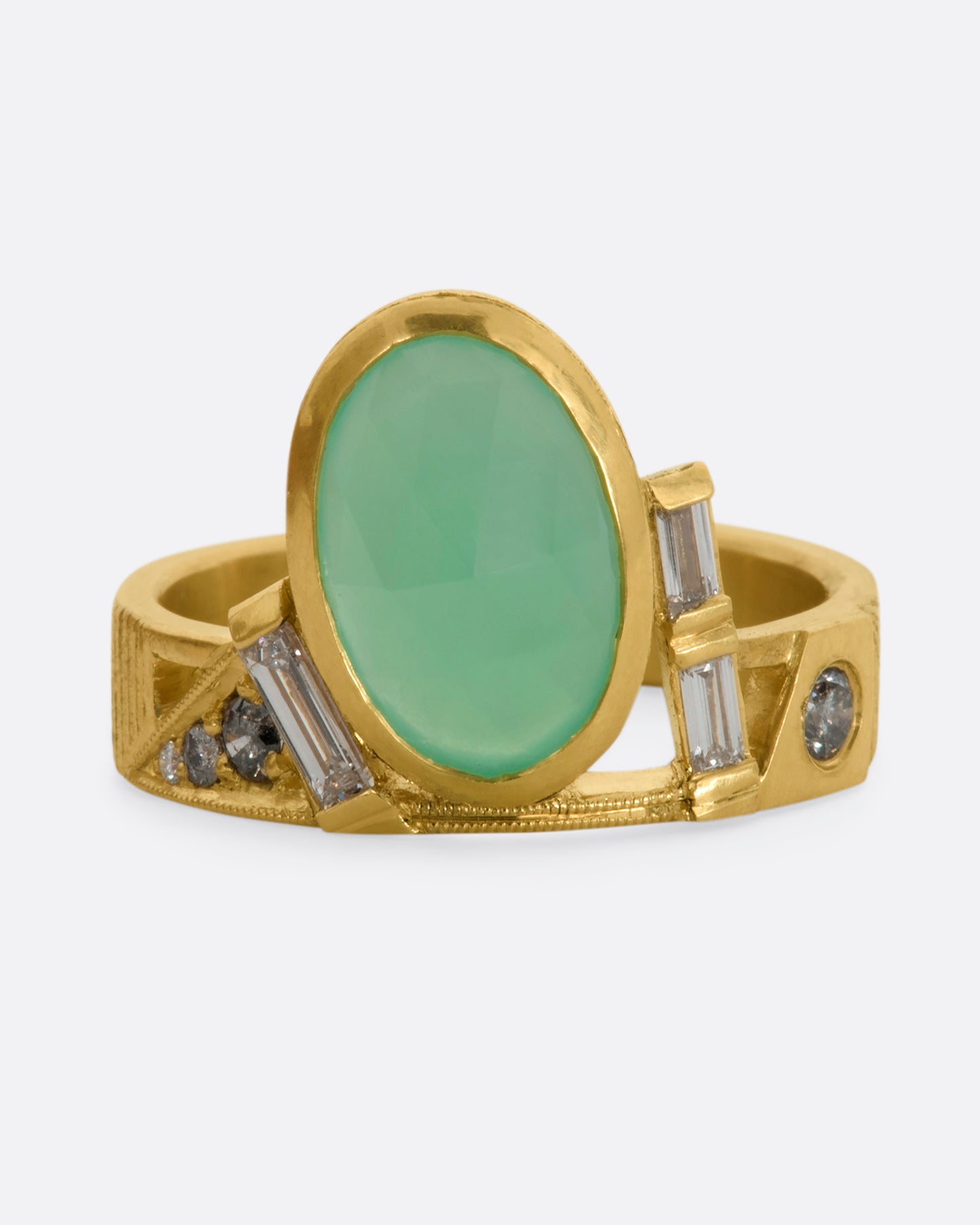 A yellow gold wide band ring with an oval chrysoprase, stacked baguette and round diamonds. View from the front.