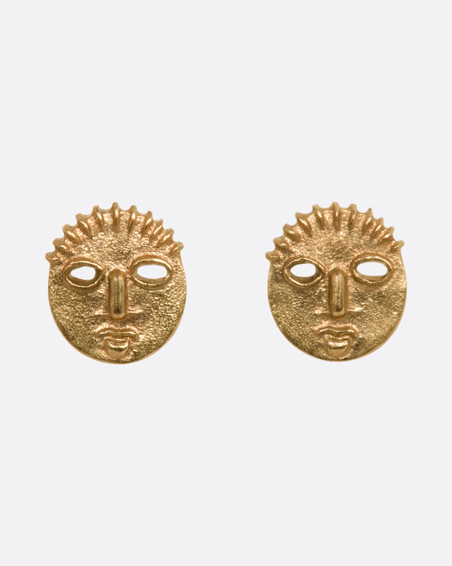 Yellow gold mask stud earrings. View from the front.