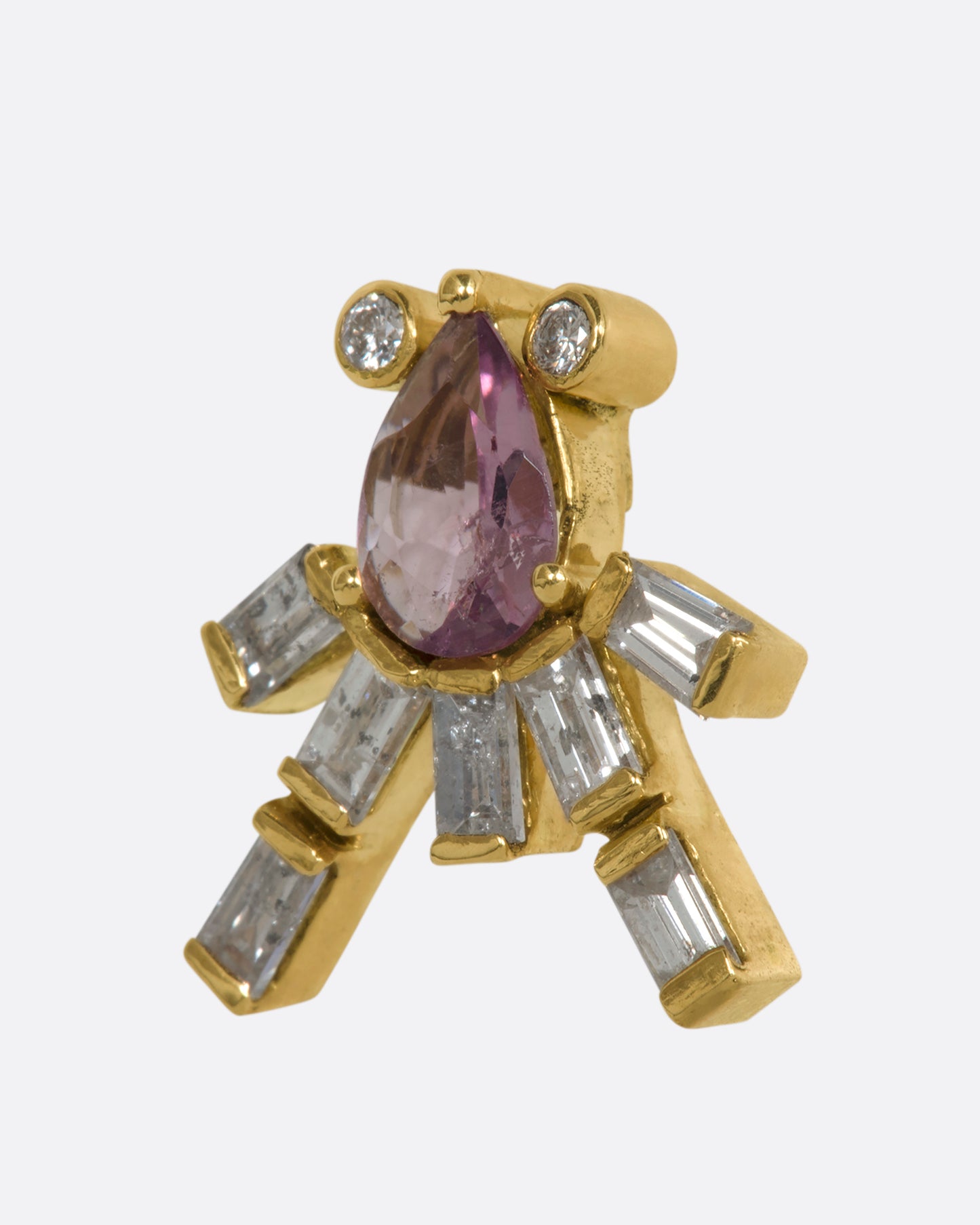 A yellow gold earring shaped like an abstract octopus made of pink sapphires and diamonds. Shown from the side.